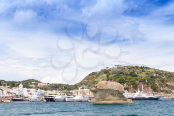 Coastal landscape of Ischia island, Italy. Lacco Ameno port with natural landmark Il Fungo, mushroom shaped rock