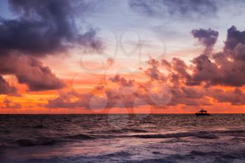 Red sky over Atlantic Ocean coast at sunset, Bavaro beach, Hispaniola Island. Dominican Republic, coastal landscape