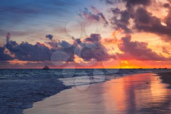 Colorful dramatic sunrise over Atlantic Ocean. Bavaro beach, Hispaniola Island. Dominican Republic, coastal landscape