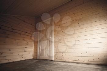 White door in dark empty room, wooden interior background