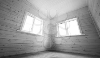 Two white windows in empty room, wooden interior background. Black and white photo
