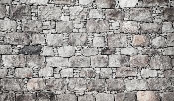 Old gray stone wall, flat background photo texture