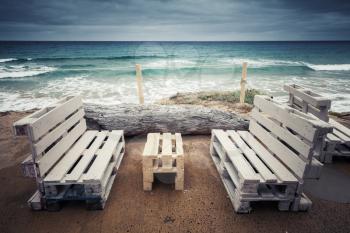 Standard white wooden furniture made of cargo pallets, cheap seaside terrace on Porto Santo, Madeira archipelago, Portugal