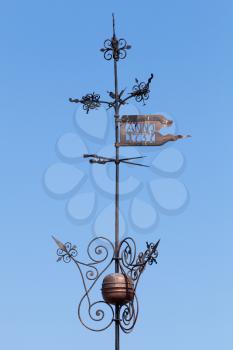 Vintage weather vane above blue sky. Top of old fortress tower in Tallinn, Estonia