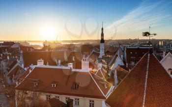 Morning cityscape with rising sun light in old town of Tallinn, Estonia