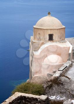 Small church with sea on background on Santorini island, Greece.