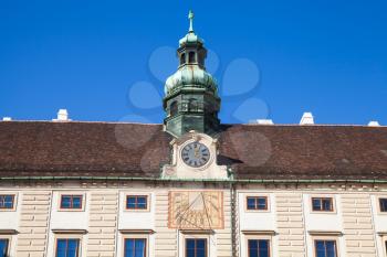 Facade of Amalienburg with sundial and clock, Vienna, Austria