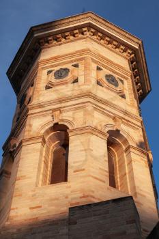Fermo town, Italy. Old clock tower facade in evening sunlight, Italy