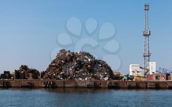 Big pile of rusted scrap metal lies on the quay in Burgas port, Bulgaria
