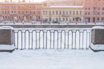 Griboyedov Canal forged fence at winter day. Cityscape of Saint-Petersburg, Russia