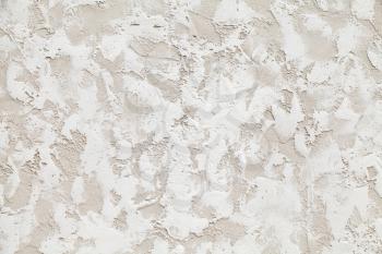 Wall with white decorative relief stucco pattern, background photo texture