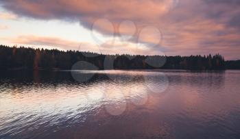 Colorful clouds over still lake in evening, natural background photo