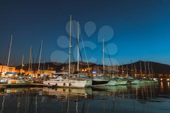 Pleasure sailing yachts and motor boats moored in port of Ajaccio at dark night, Corsica island, France