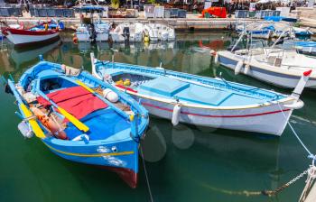 Colorful fishing boats moored in old port of Ajaccio, Corsica, France
