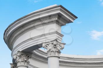Classical round portico fragment, white columns under blue sky