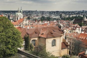 Prague old town roofs in summer day, vintage stylized photo with tonal correction filter