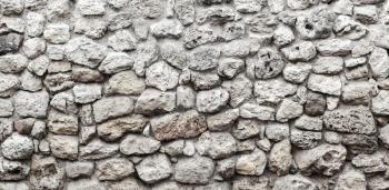 Old gray stone wall background photo texture, front view