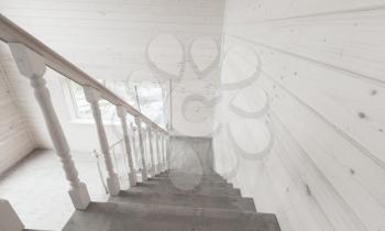 White stairway railings. Empty new wooden house interior fragment