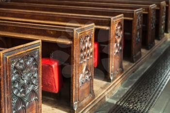 Wooden prayer benches with carving in Bath Abbey. Bath, Somerset, UK