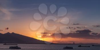 Dramatic colorful sunset over Mediterranean sea. Landscape with ships in bay of Izmir city, Turkey