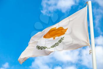 National flag of Cyprus waving on wind over blue sky background