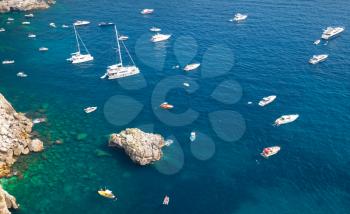 Mediterranean seascape, bird eye view. Pleasure yachts and motorboats moored near coastal rocks