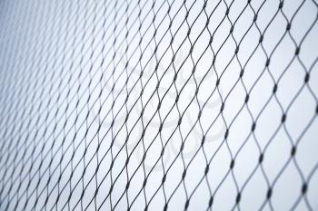 Steel chain link fence background texture with selective focus