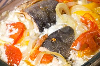 Seafood theme. Pink salmon baked in cream with vegetables closeup photo