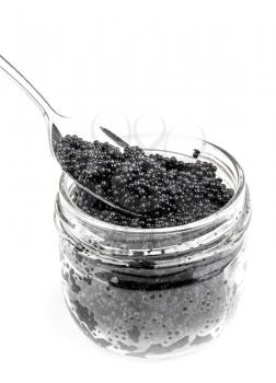 Black caviar in a glass jar with spoon isolated on white background