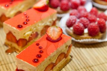 Piece of cake with strawberries and raspberries, selective focus