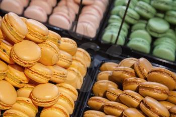 Colorful traditional French macarons lay  in the bakery