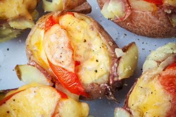 Homemade baked potato with tomato, bacon and cheese
