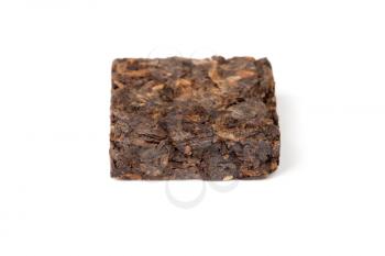 Small pressing square briquette of black Chinese Shu Pu-erh tea isolated on white background