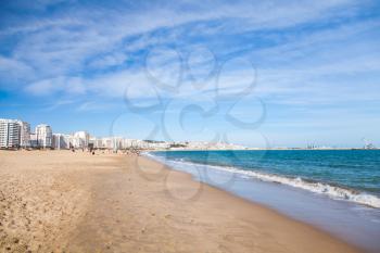 Tangier public beach with walking local people. Coastal landscape, Morocco, Africa