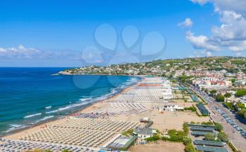 Wide public beach of Gaeta resort town, Italy. Mediterranean Sea. Coastal landscape