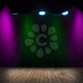Dark scene interior with spotlights, wooden stage and colorful background