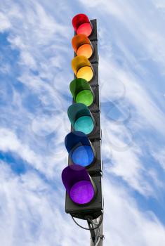Seven-color rainbow scheme traffic light concept above blue sky