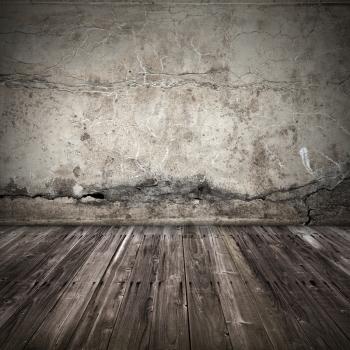 Old dark grunge interior background with concrete wall and weathered wooden lining boards floor