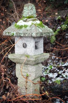 Old outdoor Chinese streetlight made of stone in winter park 