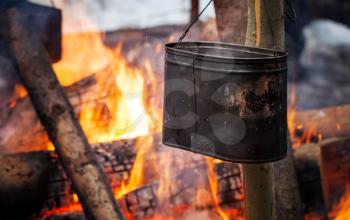 Bonfire with metal black kettle