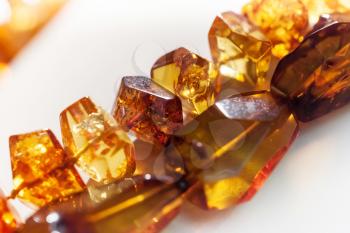 Macro photo of amber beads on white background