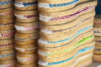 Colorful espadrilles for sale on a small shop counter in Calafell town, Catalonia, Spain