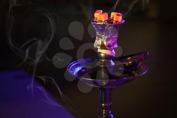 Fragment of hookah with burning coals in the night club of Manama, Bahrain