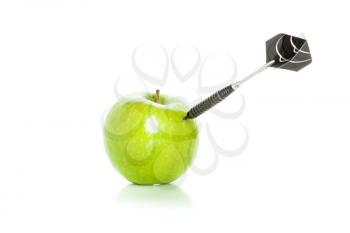 Green apple as a target for black steel dart, closeup photo on white background