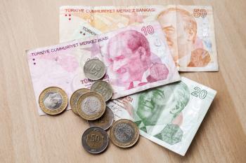 Different banknotes and coins. Turkish money on wooden table background