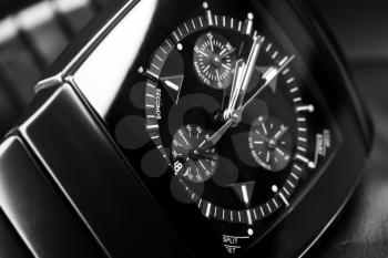 Luxury mens chronograph watch made of black high-tech ceramics. Close-up studio photo with selective focus