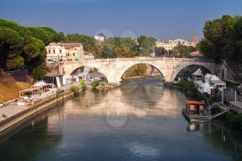 Cityscape of Rome, summer evening. The Pons Cestius or Ponte Cestio in Italian is a Roman stone bridge in Rome, Italy, spanning Tiber river to the west of the Tiber Island