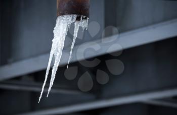 icicle on the dark industrial background