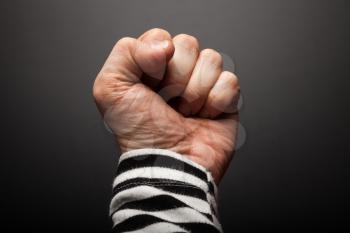Close-up photo of sailor fist  on a dark background