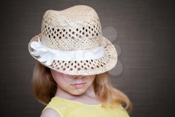 Little blond girl wearing straw hat